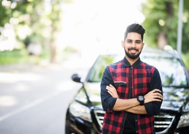 Young man by car